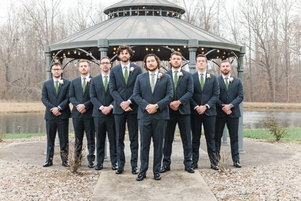 Groomsmen posing at the Hidden Homestead in Smiths Grove, Kentucky during a winter wedding. 