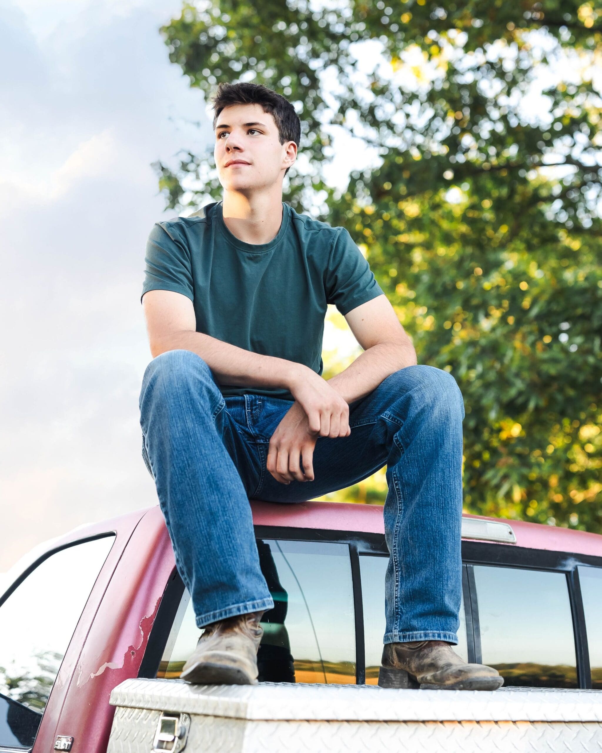 Senior guy portrait session in Bowling Green KY featuring a truck and rustic countryside setting in the fall evening sun, shot by Jordan Z Photography