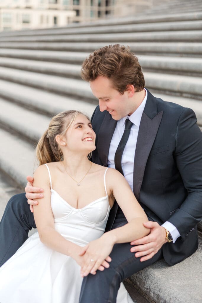 Couple embracing each other at their engagement session on the steps of the Indiana War Memorial in downtown Indianapolis, shot by Jordan Z Photography