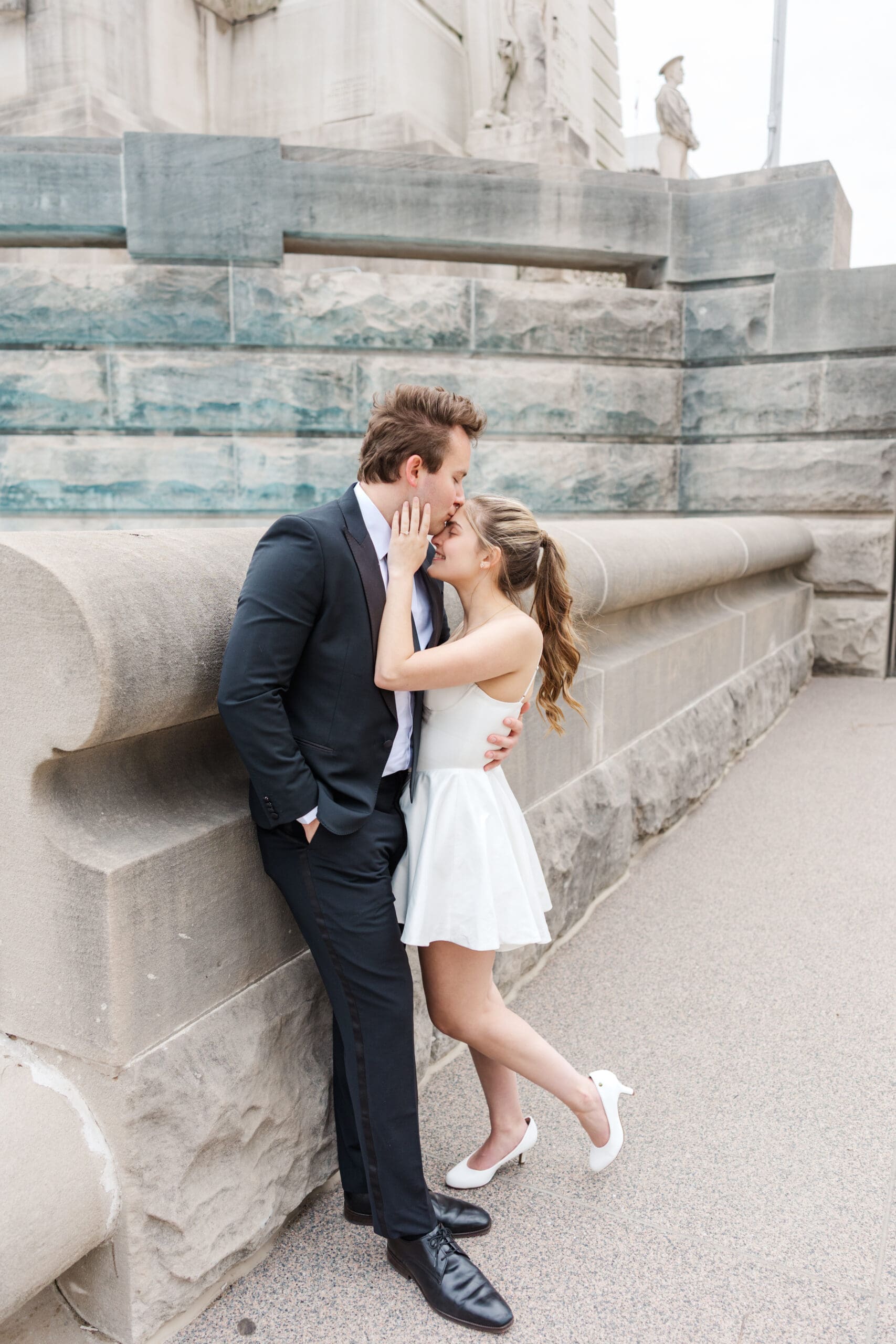Romantic image of engaged couple sharing a quiet moment under the archways of the Indiana War Memorial, shot by Jordan Z Photography