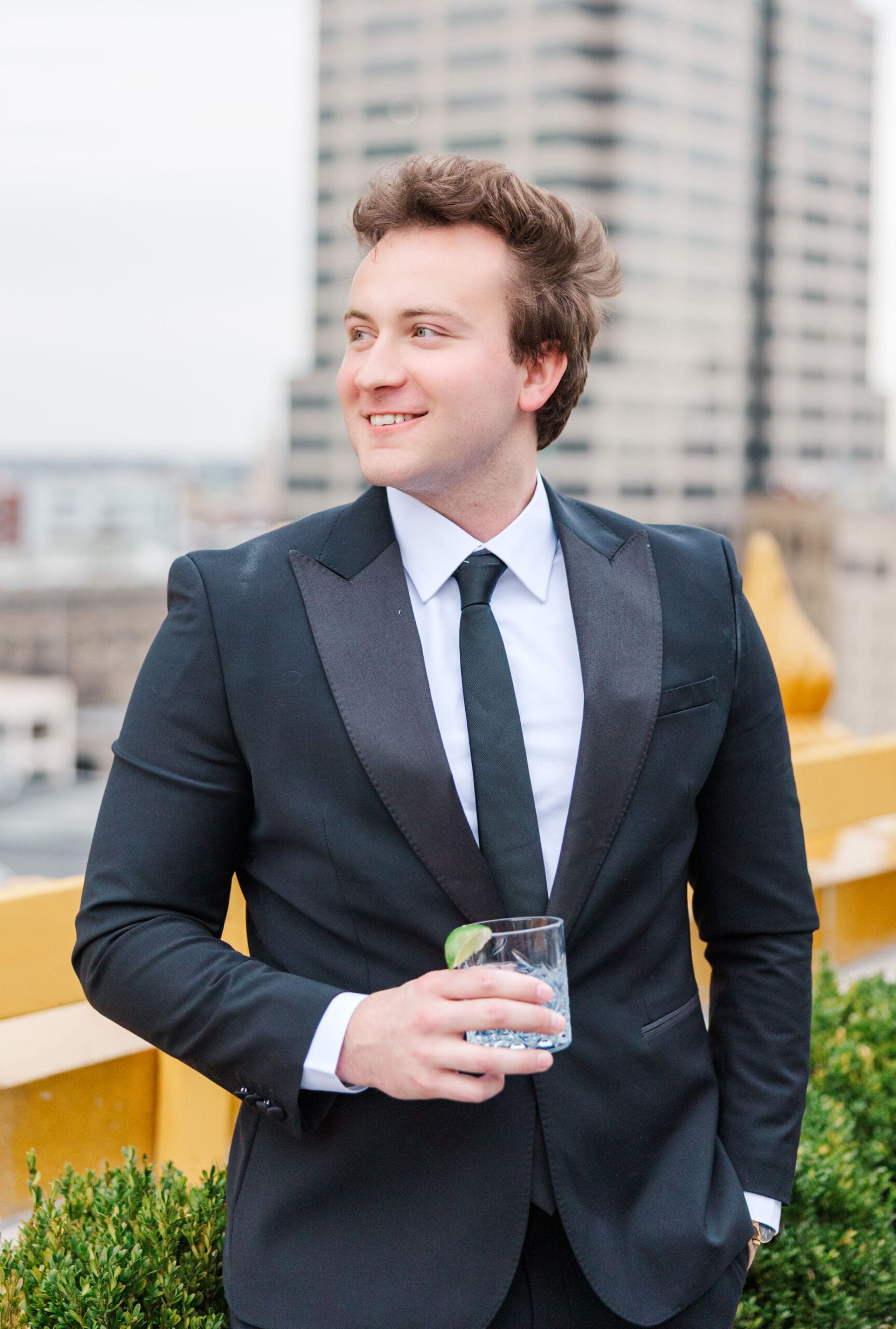 Groom enjoying the sweeping city views at his engagement session